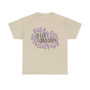 NerdyKeppie "Queer Liberation" - Lauren Denitzio Tee Shirt (PostNormCore Exclusive). A tee shirt designed by Lauren Denitzio, with the phrase "QUEER LIBERATION" across the chest, surrounded by small lavender flowers. Profits from this tee shirt benefit Jake's gender-affirming surgeries.