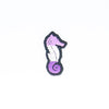 NerdyKeppie's Queer (Purple) Seahorse Embroidered Pride Patch are shaped like their namesake and stitched on black duck cloth!