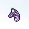 NerdyKeppie's Queer (Purple) Zebra Embroidered Pride Patch are shaped like their namesake and stitched on black duck cloth!