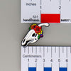 NerdyKeppie Proud to the Bone Parasauralophus Skull Pride Enamel Pins. A Parasauralophus skull pride enamel pin for our Proud to the Bone project. This prehistoric pin is wearing an adorable crown of flowers!