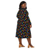 A person wearing a NerdyKeppie Raveyard Ghosts Progress Pride Long Sleeve Midi Dress With Pockets. 