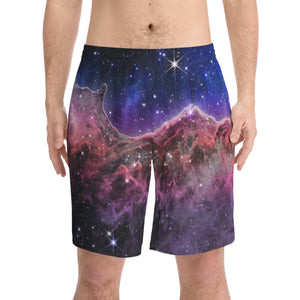 NerdyKeppie Carina Nebula Genderfluid Pride Swim Trunks With Pockets. A pair of swim trunks featuring a Carina Nebula design in genderfluid pride colors. These genderfluid pride swim trunks are machine washable.