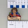 NerdyKeppie Sappho Historically Queer Enamel Pride Pin. Our NerdyKeppie Historically Queer Pride enamel pin features Sappho surrounded by flowers in your choice of lesbian, bisexual, or rainbow pride colors. This pride pin ships from Portland, Oregon.