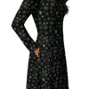 A person wearing a NerdyKeppie Scattered Dice Aro Pride Long Sleeve Midi Dress With Pockets. 