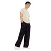 A person wearing a NerdyKeppie Scattered Dice Genderfluid Pride Unisex Wide-Leg Pants With Pockets. 