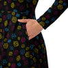 A person wearing a NerdyKeppie Scattered Dice Pan Pride Long Sleeve Midi Dress With Pockets. 