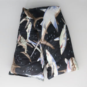 A NerdyKeppie Shark Swarm Heat & Cold Packs. A microwaveable heat and cold pack featuring a shark-themed design, a great gift for anyone who has to deal with shark week or just likes sharks.