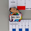 NerdyKeppie Capybara Enamel Progress Pride Pronoun Pins. Our enamel pin features an adorable capybara, a paper scroll with six different pronoun choices, and flowers in Progress pride colors. This pride pin ships from Portland, Oregon.