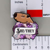 NerdyKeppie Capybara Enamel Queer Pride Pronoun Pins. Our enamel pin features an adorable capybara, a paper scroll with seven different pronoun choices, and flowers in queer pride colors. This pride pin ships from Portland, Oregon.