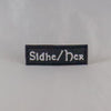 NerdyKeppie's "Sidhe/Her" Embroidered Pronoun Patches are stitched on sturdy rectangular duck cloth and backed with vinyl fuse.