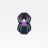 NerdyKeppie's Spider Embroidered Pride Patch are shaped like their namesake and stitched on black duck cloth!
