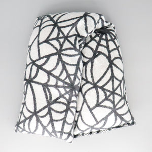 A NerdyKeppie Spider Webs Flannel Heat & Cold Packs. A microwaveable heat and cold pack featuring a spiderweb-themed design, great gift for goths or Halloween-loving friends with, you know, achy joints and stuff.