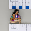 NerdyKeppie Enheduanna Historically Queer Spirit of '77 Enamel Pride Pin. Our NerdyKeppie Historically Queer Pride enamel pin features Enheduanna surrounded by flowers in your choice of transgender, non-binary, or Spirit of '77 pride colors. This pride pin ships from Portland, Oregon.