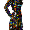 A person wearing a NerdyKeppie Splatter Wave Progress Pride Long Sleeve Midi Dress With Pockets. 
