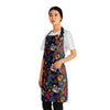 A person wearing a NerdyKeppie Stencil Roses Progress Pride Apron With Pocket. A black apron with a stencil roses design on it in progress pride colors. This gay pride pocket apron is made of durable 100% polyester.
