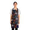 A person wearing a NerdyKeppie Stencil Roses Progress Pride Apron With Pocket. A black apron with a stencil roses design on it in progress pride colors. This gay pride pocket apron is made of durable 100% polyester.