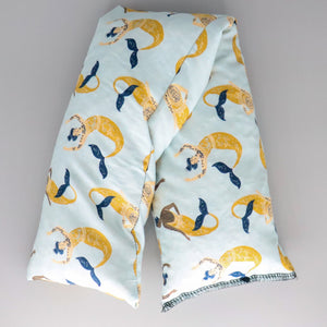 A NerdyKeppie Tattooed Mermaids Heat & Cold Pack. A microwaveable heat and cold pack featuring a mermaid-themed design, great gift for friends with, you know, achy joints and stuff.