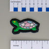 NerdyKeppie's Trans Painted Turtle Embroidered Pride Patch are shaped like their namesake and stitched on black duck cloth!