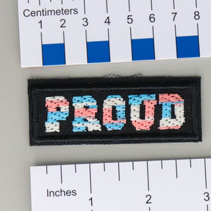 NerdyKeppie's Trans "Proud" Embroidered Pride Patch are stitched on sturdy rectangular duck cloth and backed with vinyl fuse.
