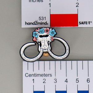 NerdyKeppie Proud to the Bone Wooly Mammoth Skull Pride Enamel Pins. A Wooly Mammoth skull pride enamel pin for our Proud to the Bone project. This prehistoric pin is wearing an adorable crown of flowers!