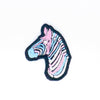 NerdyKeppie's Trans Zebra Embroidered Pride Patch are shaped like their namesake and stitched on black duck cloth!