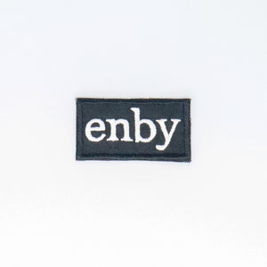 NerdyKeppie's White "Enby" Embroidered Non-Binary Pride Patch are stitched on sturdy rectangular duck cloth and backed with vinyl fuse.