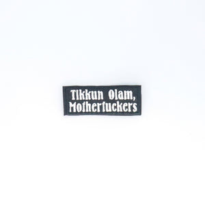 NerdyKeppie's White "Tikkun Olam, Motherfuckers" Embroidered Patch are stitched on sturdy rectangular duck cloth and backed with vinyl fuse.