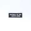 NerdyKeppie's White "Workers of the World Unite" Embroidered Patch are stitched on sturdy rectangular duck cloth and backed with vinyl fuse.