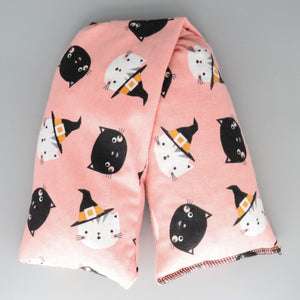 A NerdyKeppie Witchy Kitties on Pink Flannel Heat & Cold Pack. A microwaveable heat and cold pack featuring a kitty-themed design, great gift for friends with, you know, achy joints and stuff.