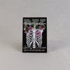 NerdyKeppie Proud to the Bone Human Ribcage Pride Enamel Pins. A human ribcage pride enamel pin for our Proud to the Bone project, wearing an adorable crown of flowers!