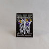 NerdyKeppie Proud to the Bone Human Ribcage Pride Enamel Pins. A human ribcage pride enamel pin for our Proud to the Bone project, wearing an adorable crown of flowers!
