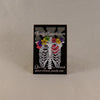NerdyKeppie Proud to the Bone Human Ribcage Pride Enamel Pins. A human ribcage pride enamel pin for our Proud to the Bone project, wearing an adorable crown of flowers!