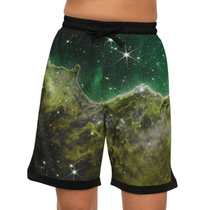 A person wearing a NerdyKeppie Carina Nebula Aro Pride Basketball Shorts with Pockets. A pair of basketball shorts featuring a aromantic Carina Nebula pattern. These aro pride basketball shorts fall just above the knee and have big pockets.